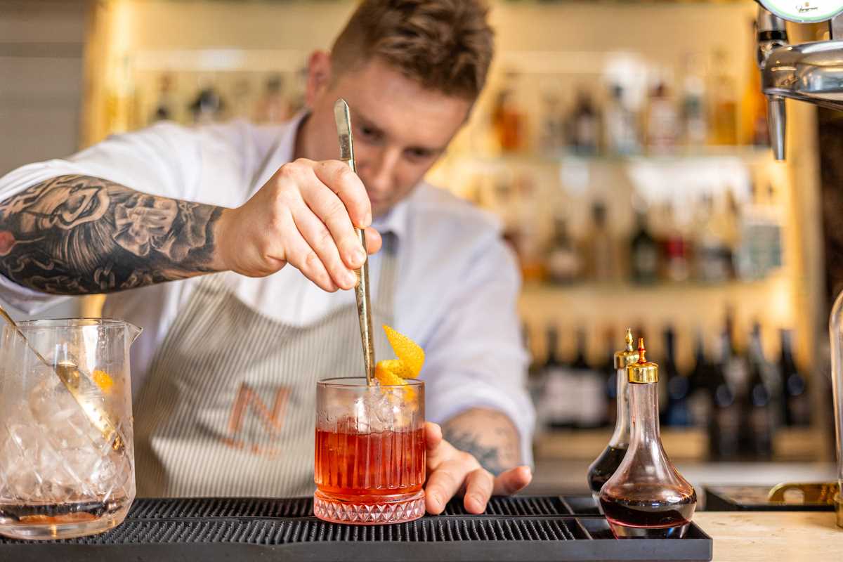 barman making cocktail